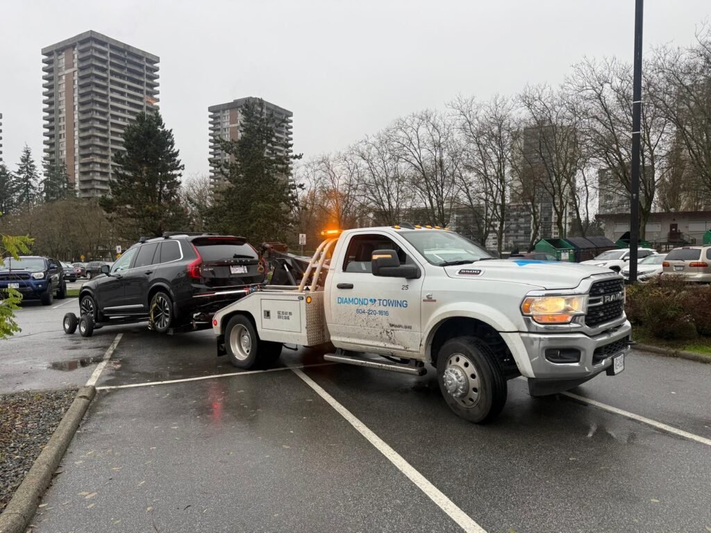 black jeep getting towed by diamond towing truck